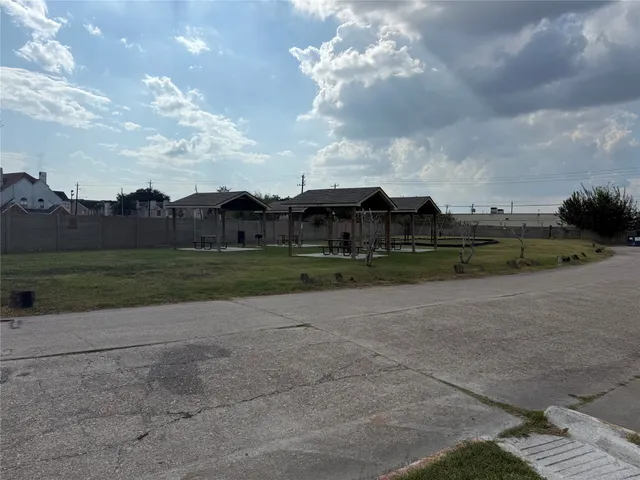 a view of a big yard with palm trees