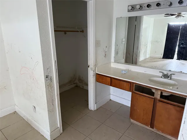 a bathroom with a granite countertop toilet sink and mirror