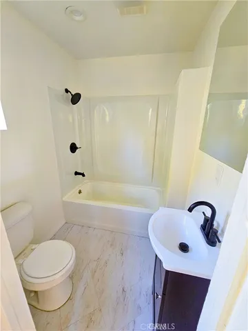 a bathroom with a sink a toilet and bathtub