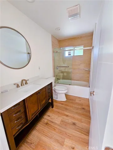 a bathroom with a sink mirror vanity and toilet