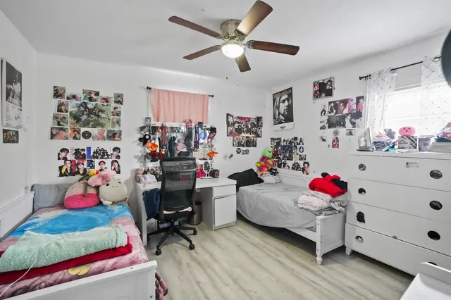 a bedroom with baby toys and a large window