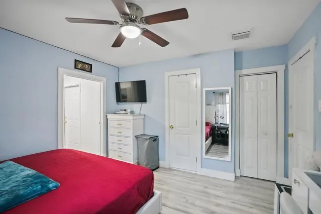 a bedroom with a bed and a flat screen tv