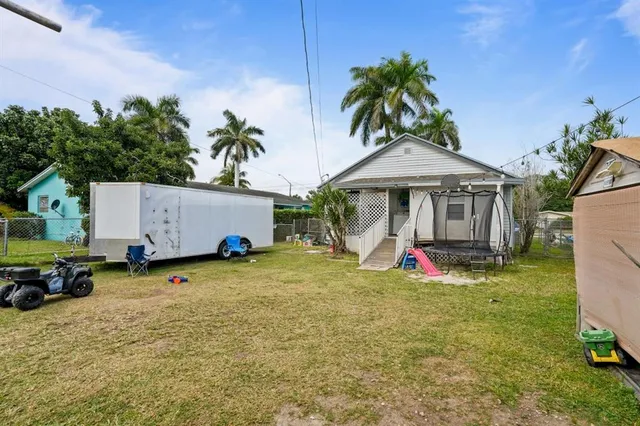 a view of a house with backyard porch and sitting area