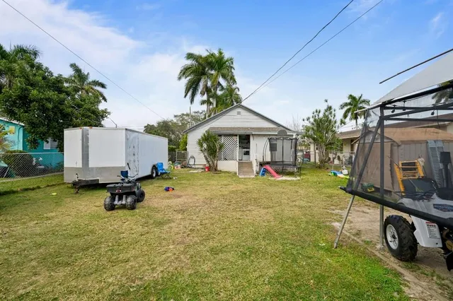 a backyard of a house with table and chairs