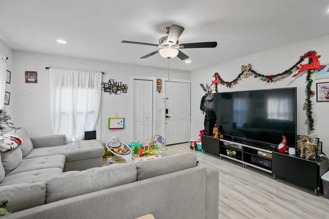a living room with furniture and a flat screen tv