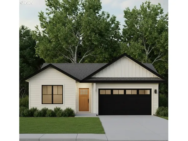 a front view of a house with a garden and yard