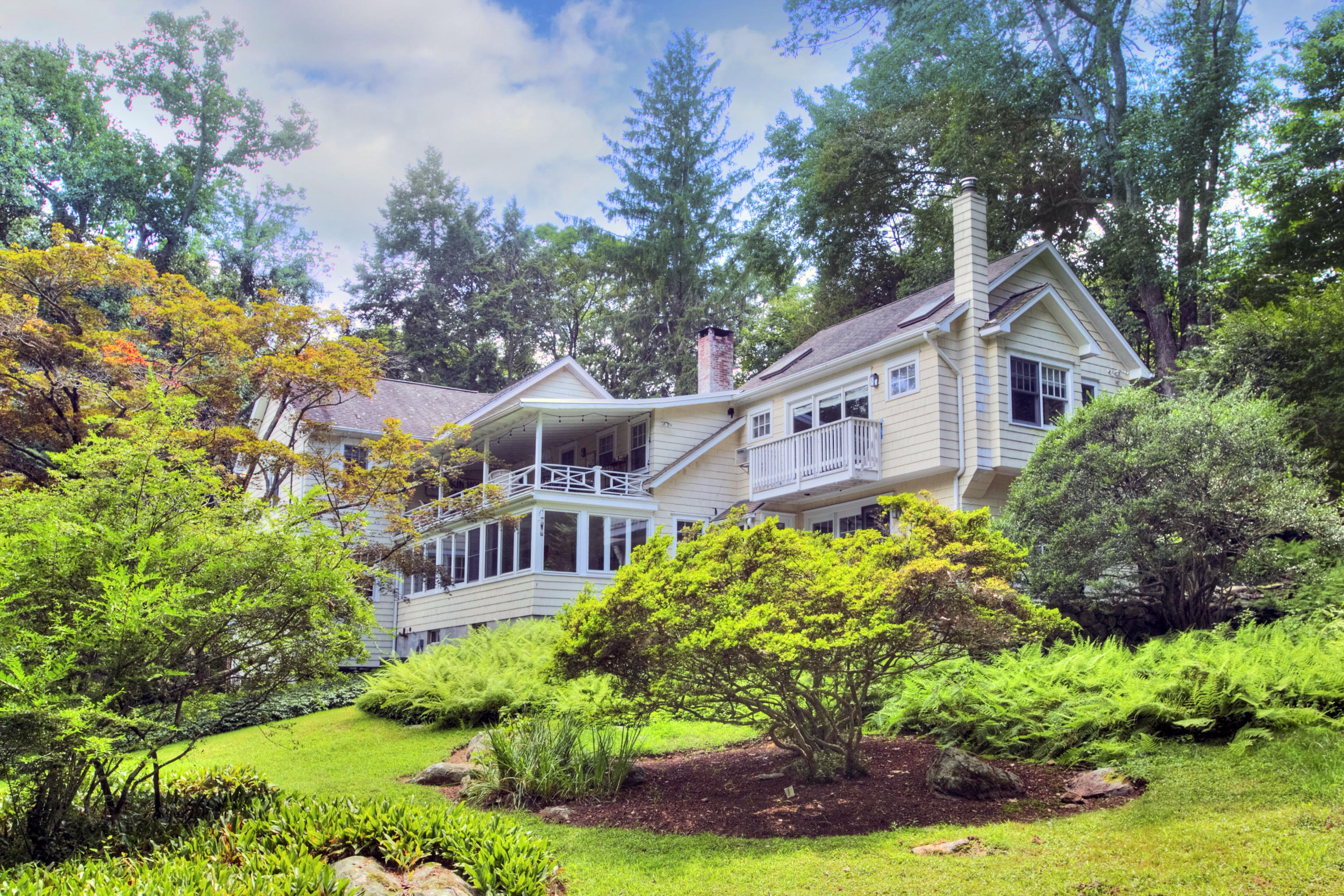 1006 Silvermine Road New Canaan, CT 06840 - Photo 1 of 39 a front view of a house with yard and green space