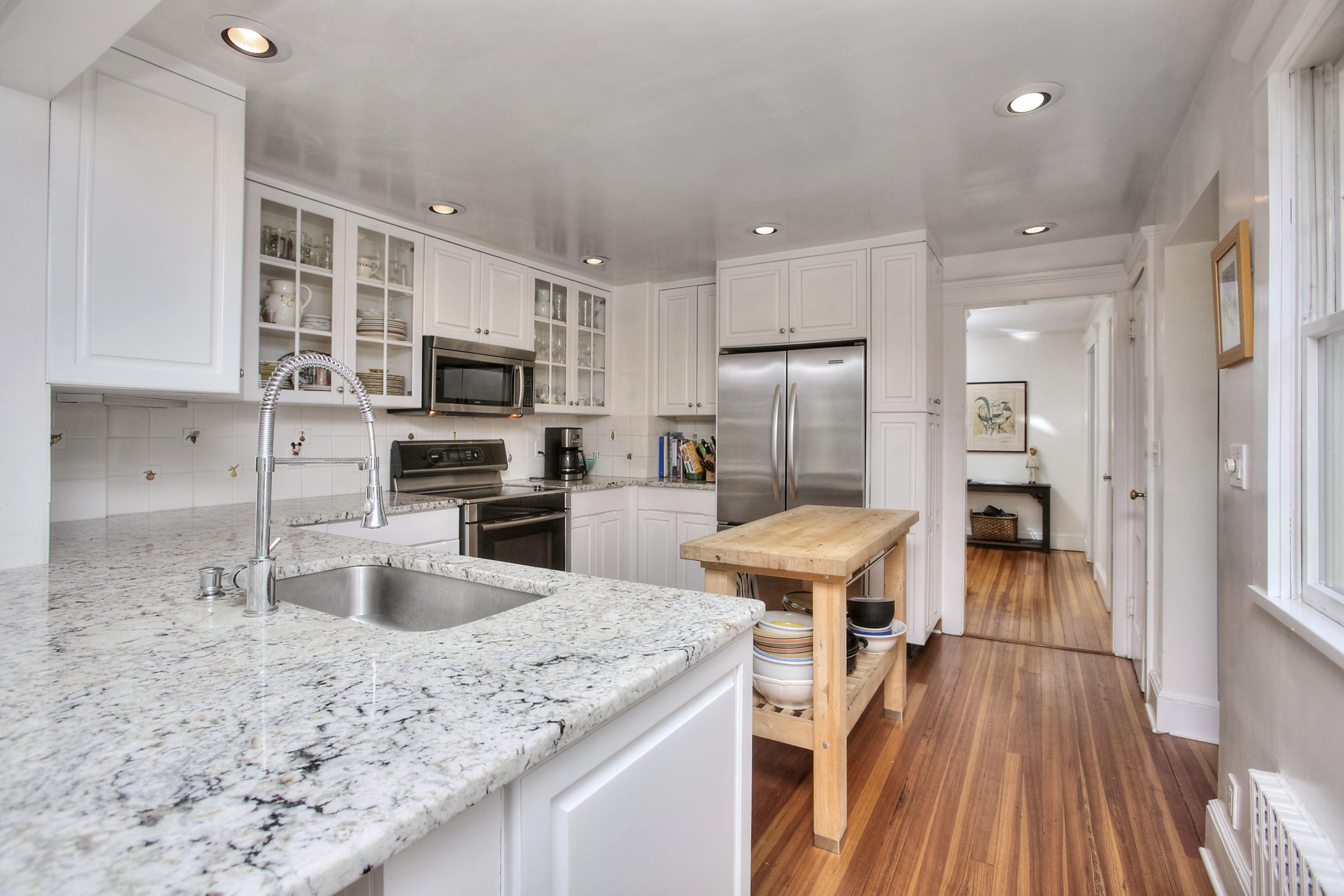 1006 Silvermine Road New Canaan, CT 06840 - Photo 12 of 39 a kitchen with stainless steel appliances granite countertop a refrigerator oven a sink dishwasher and white cabinets with wooden floor