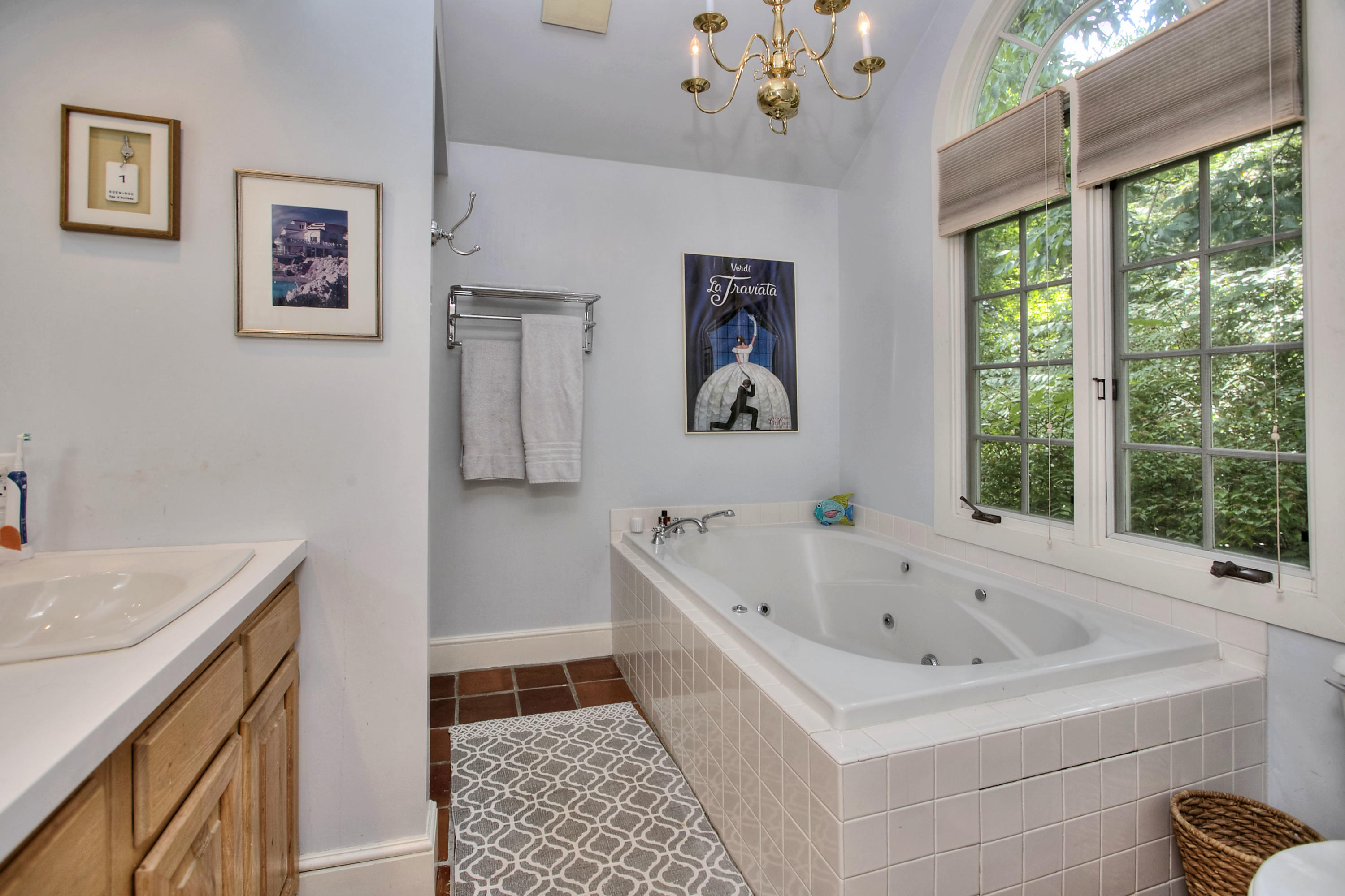 1006 Silvermine Road New Canaan, CT 06840 - Photo 20 of 39 a bathroom with a tub sink and large window
