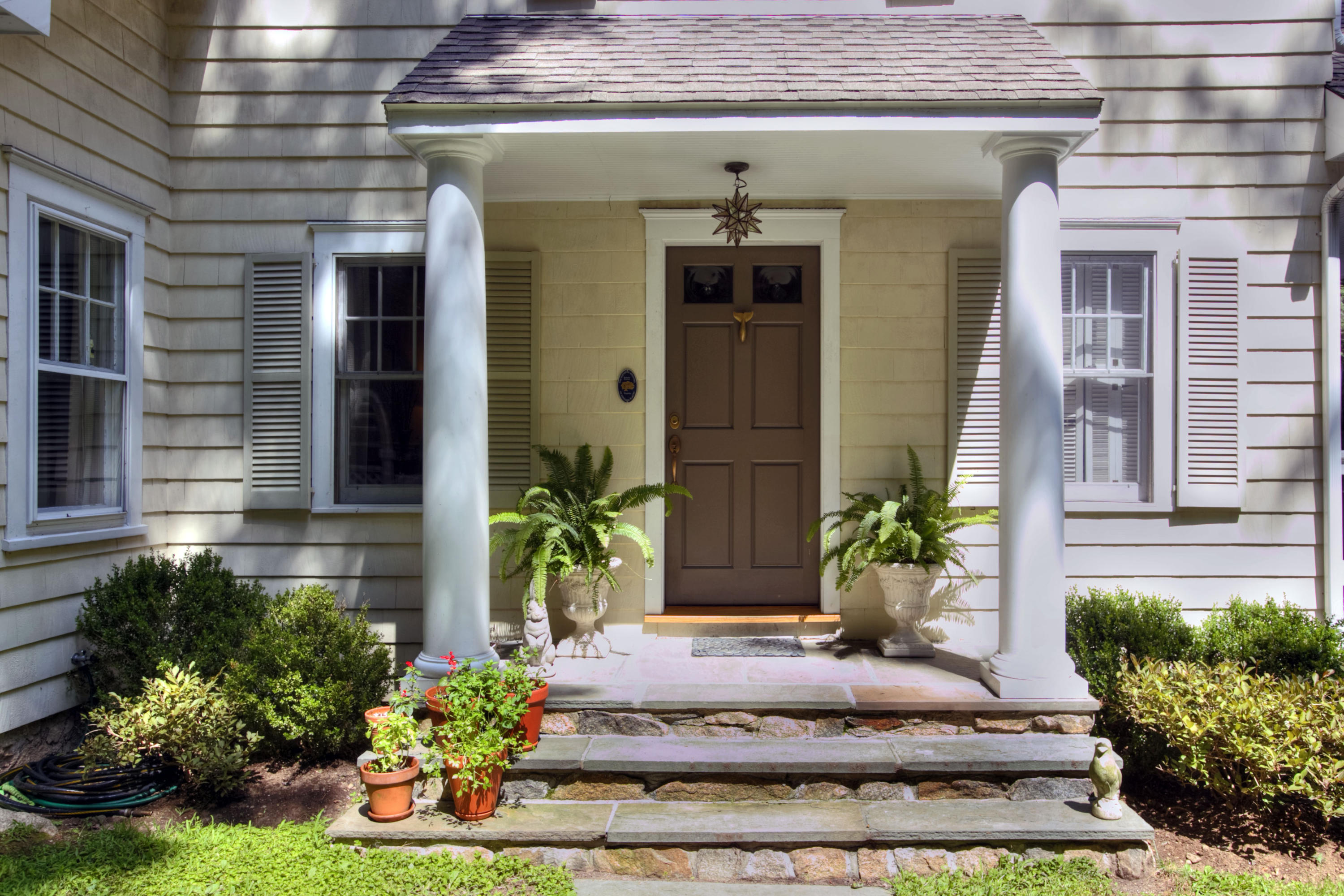 1006 Silvermine Road New Canaan, CT 06840 - Photo 2 of 39 a view of a house with potted plants