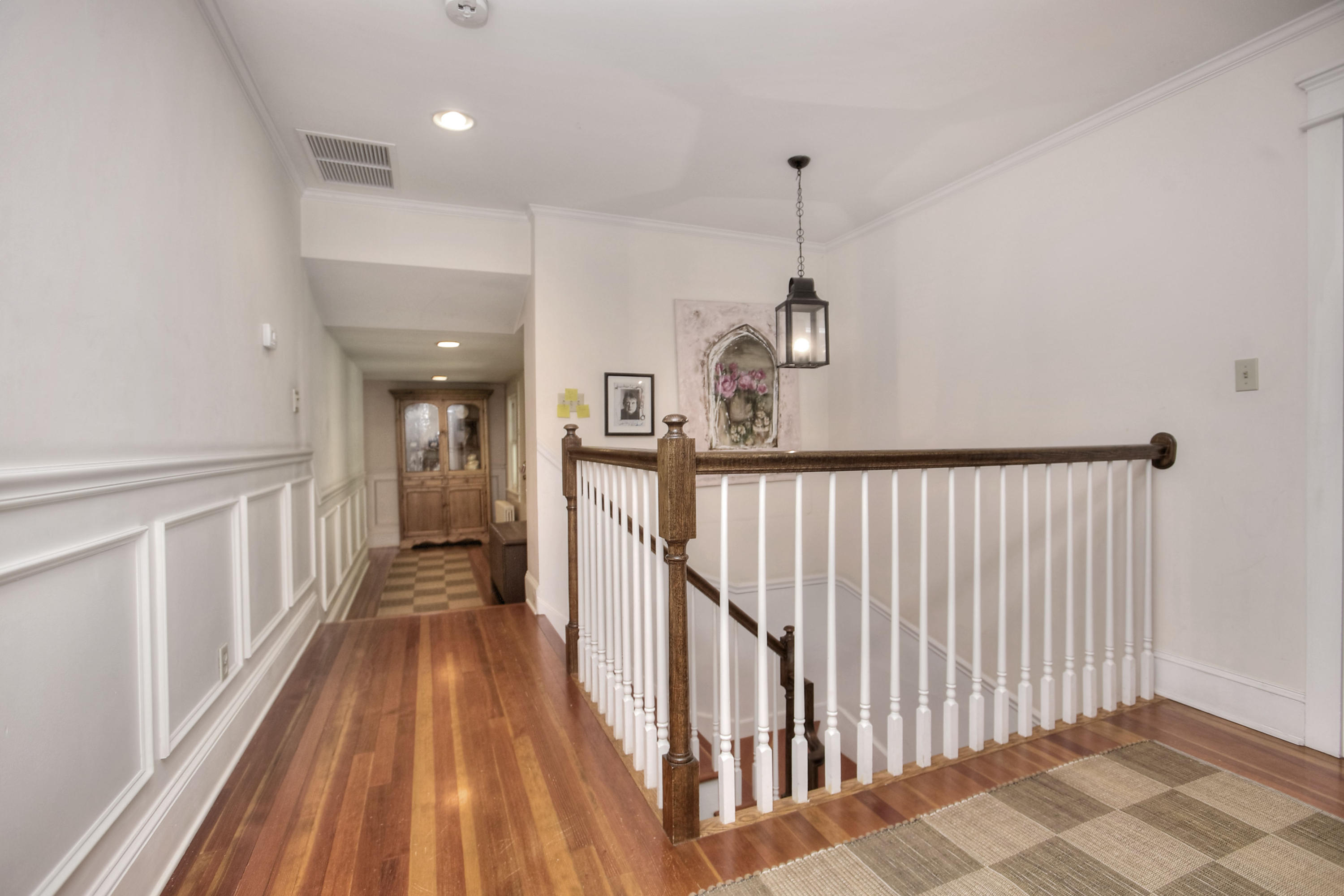 1006 Silvermine Road New Canaan, CT 06840 - Photo 29 of 39 a view of a hallway with wooden floor and stairs