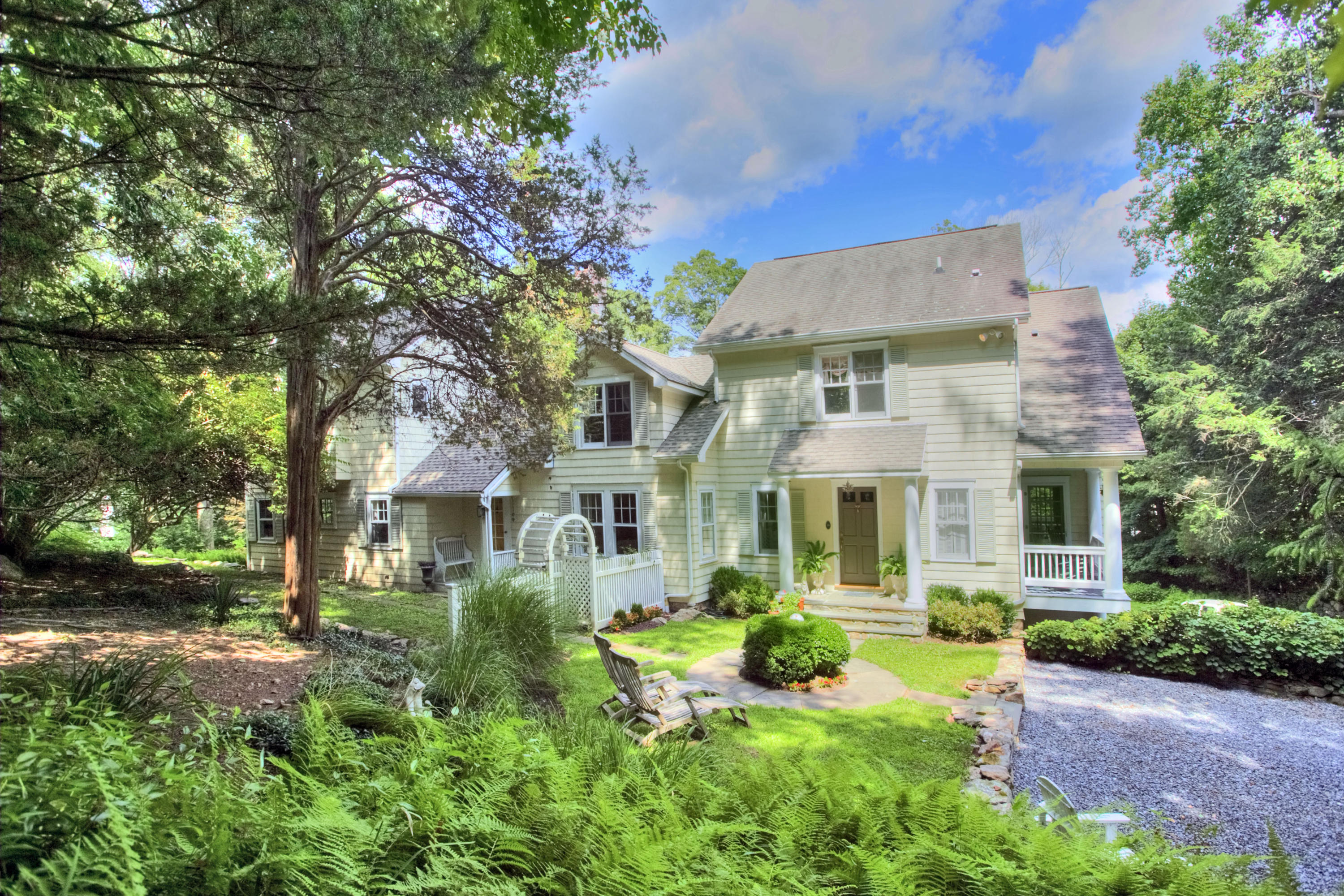 1006 Silvermine Road New Canaan, CT 06840 - Photo 37 of 39 a front view of a house with a yard