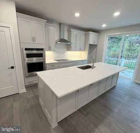 a kitchen with kitchen island a stove a sink a refrigerator and wooden cabinets
