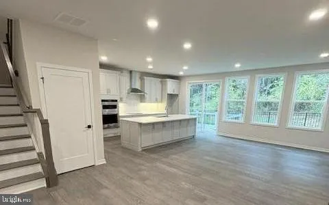 a large kitchen with a large window and refrigerator