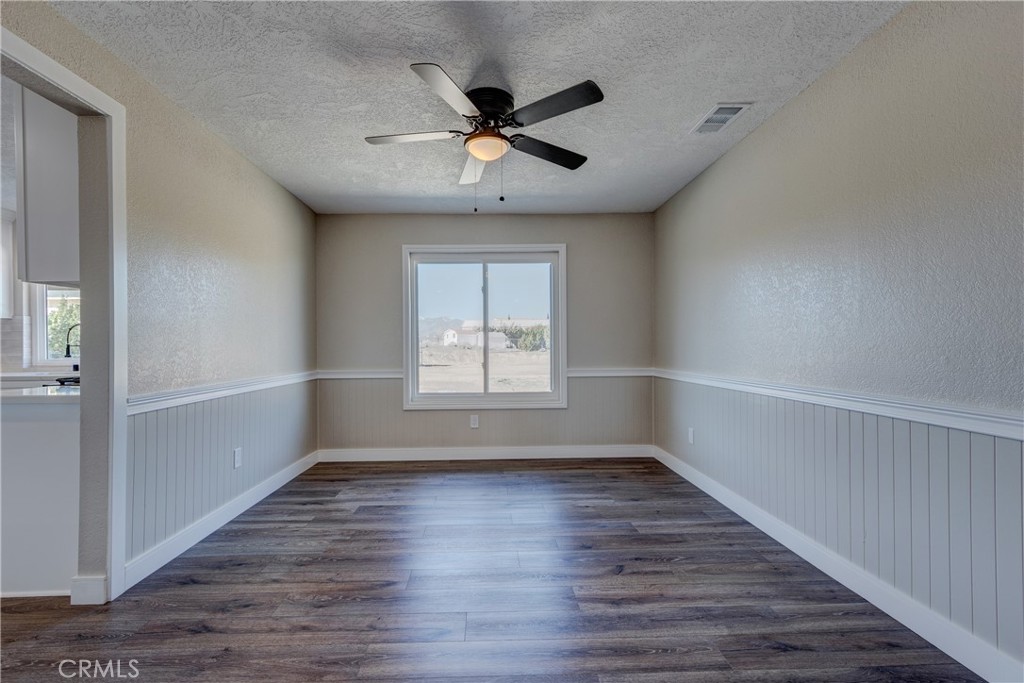 6572 Merced Road Oak Hills, CA 92344 - Photo 12 of 62 wooden floor in an empty room with a window