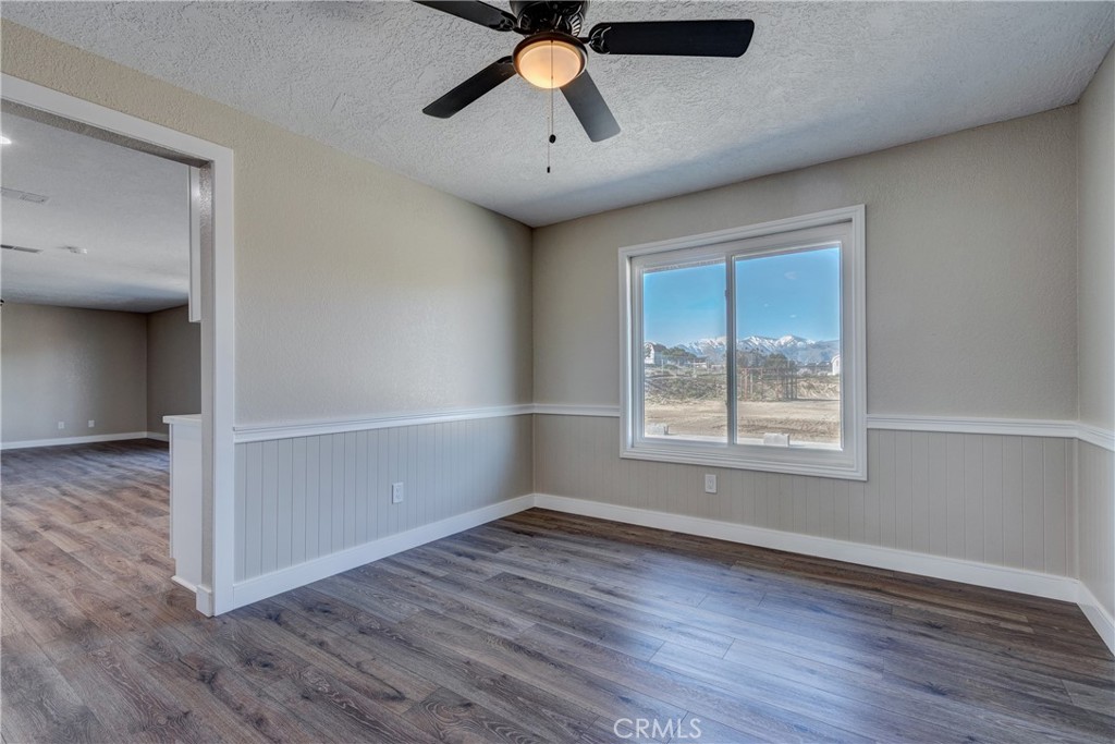 6572 Merced Road Oak Hills, CA 92344 - Photo 13 of 62 wooden floor in an empty room with a window