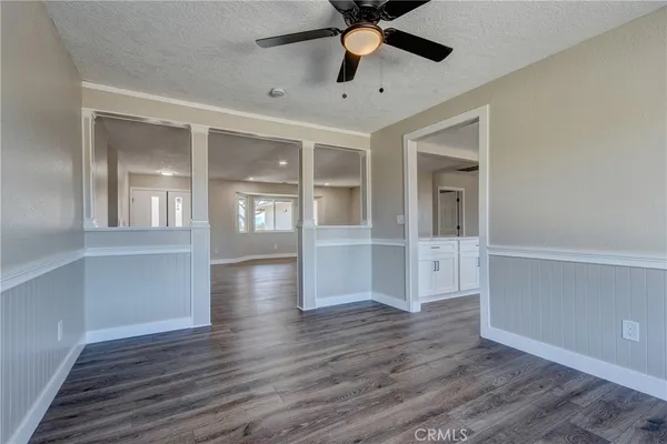 a large kitchen with granite countertop a large counter top a sink and stainless steel appliances