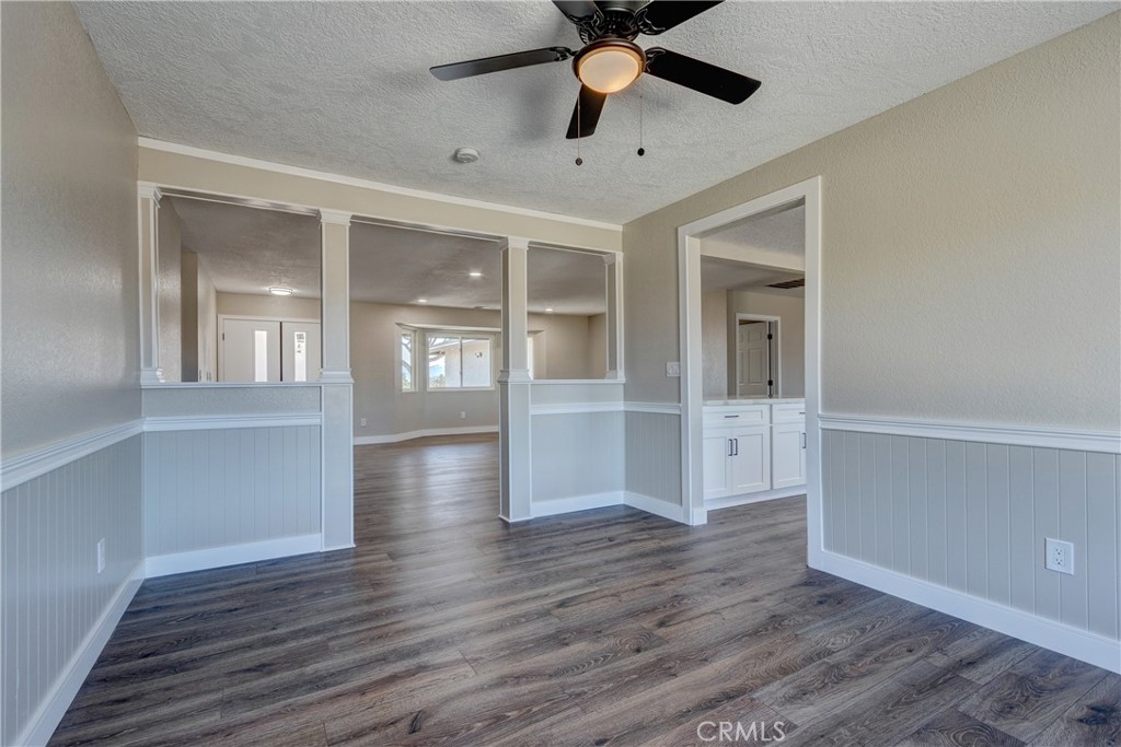 6572 Merced Road Oak Hills, CA 92344 - Photo 14 of 62 an empty room with wooden floor and windows