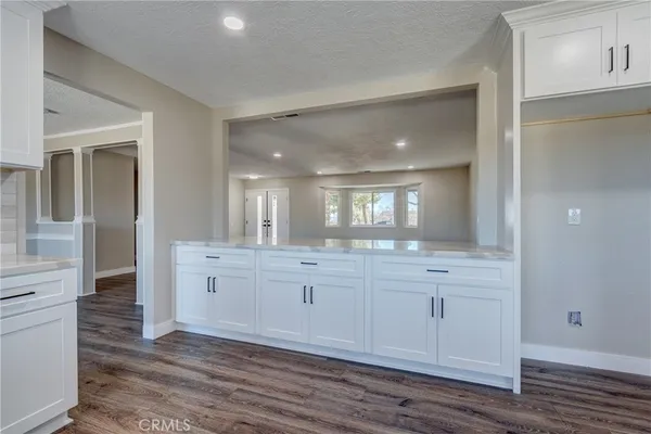 a view of a big room with wooden floor and a ceiling fan