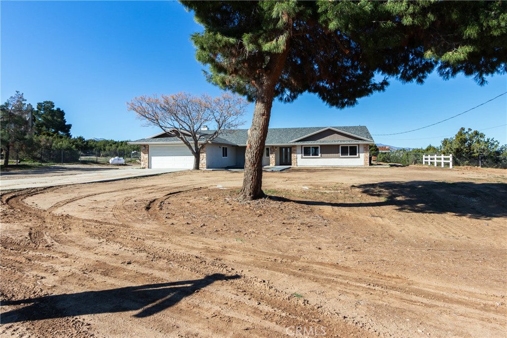 6572 Merced Road Oak Hills, CA 92344 - Photo 2 of 62 a view of a house with snow on the road