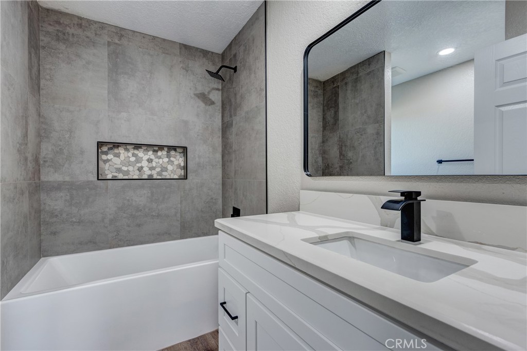 6572 Merced Road Oak Hills, CA 92344 - Photo 29 of 62 a bathroom with a sink and a bathtub
