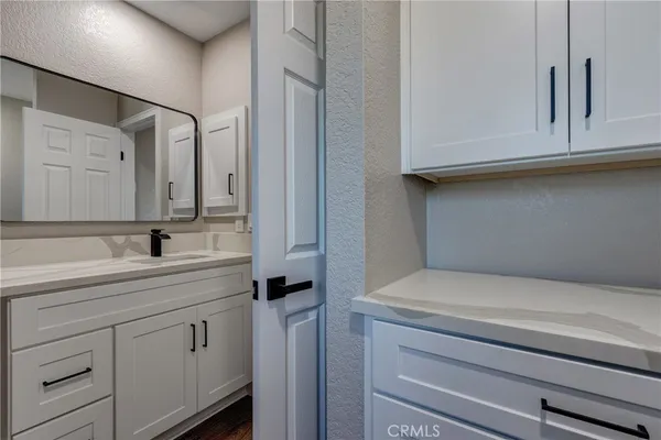 a bathroom with a granite countertop shower mirror and a sink