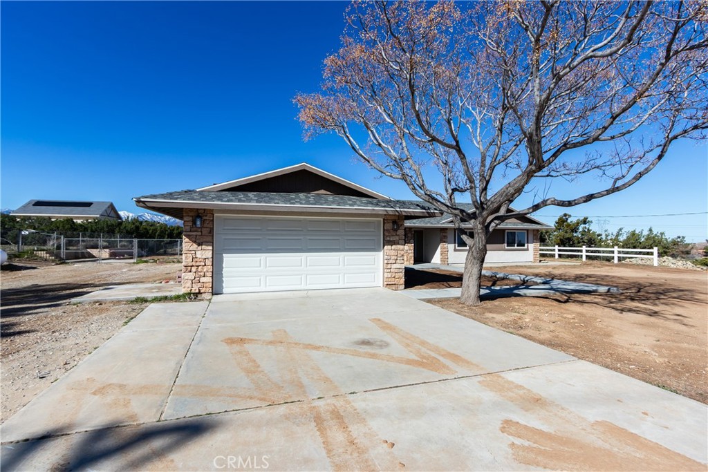 6572 Merced Road Oak Hills, CA 92344 - Photo 3 of 62 a front view of a house with a yard and garage