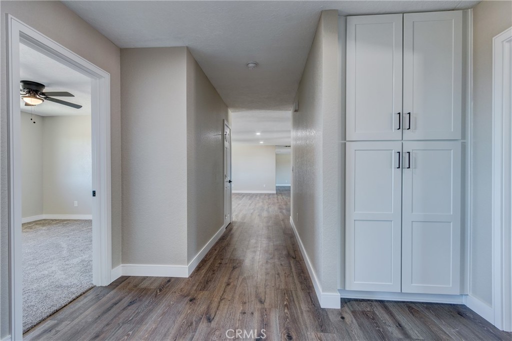 6572 Merced Road Oak Hills, CA 92344 - Photo 31 of 62 a view of a hallway with wooden floor