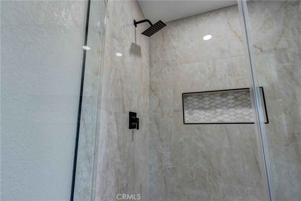 6572 Merced Road Oak Hills, CA 92344 - Photo 37 of 62 a bathroom with a shower