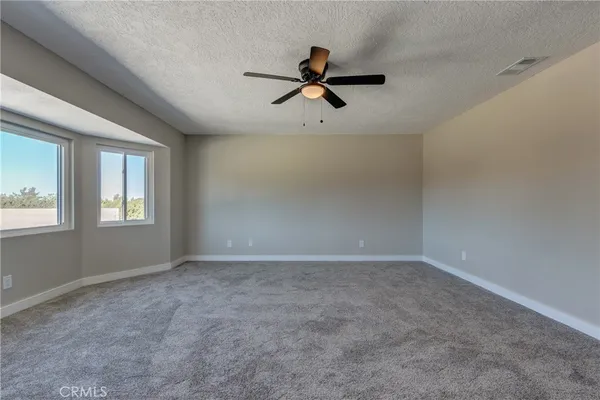 an empty room with furniture and window