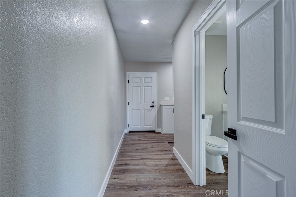 6572 Merced Road Oak Hills, CA 92344 - Photo 40 of 62 a view of a hallway with wooden floor and staircase