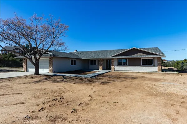 a front view of a house with yard