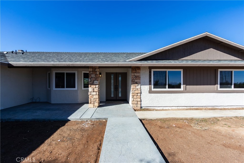 6572 Merced Road Oak Hills, CA 92344 - Photo 7 of 62 a front view of a house with a yard