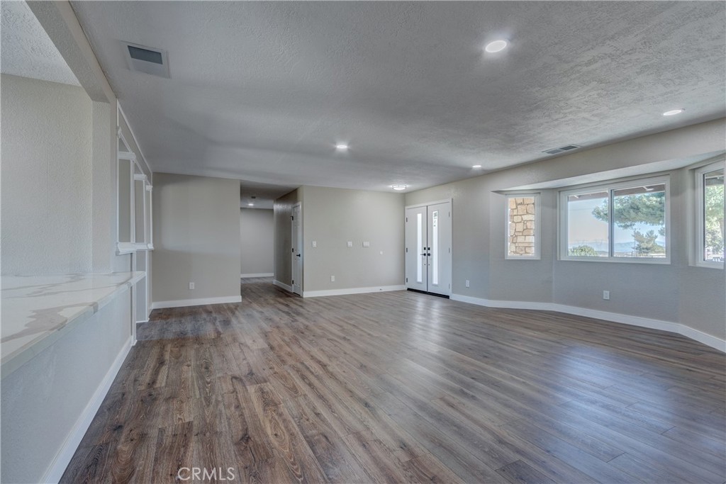 6572 Merced Road Oak Hills, CA 92344 - Photo 10 of 62 wooden floor in an empty room with a window