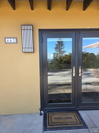 a porch with a table and chairs