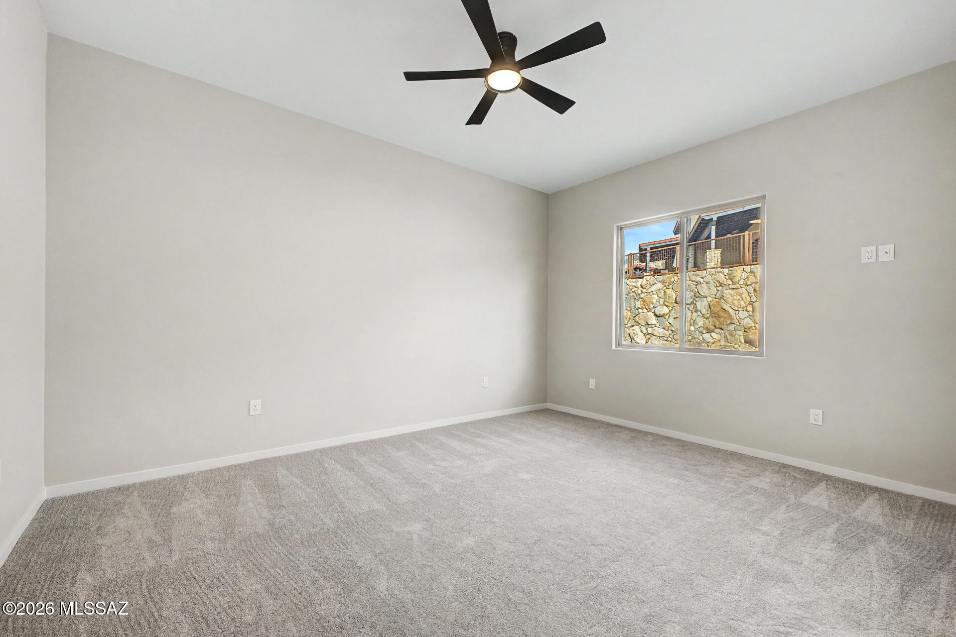 2399 Della Roccia Court Tucson, AZ 85737 - Photo 23 of 34 an empty room with a window and a fan