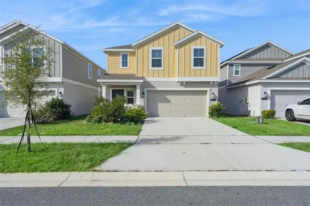 a front view of a house with a yard and garage
