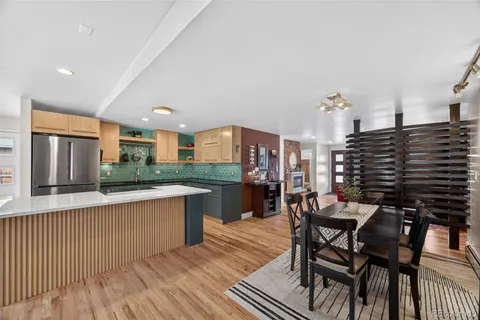 a dining room with furniture and wooden floor