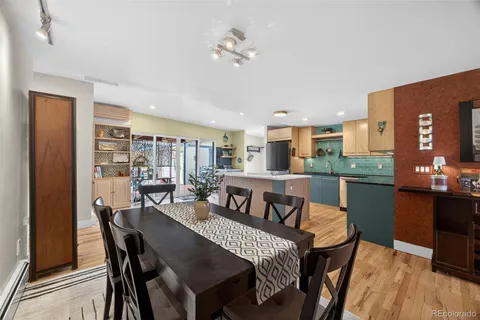 a view of a dining room with furniture and wooden floor