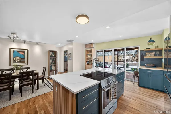 a kitchen with stainless steel appliances granite countertop a sink and a refrigerator