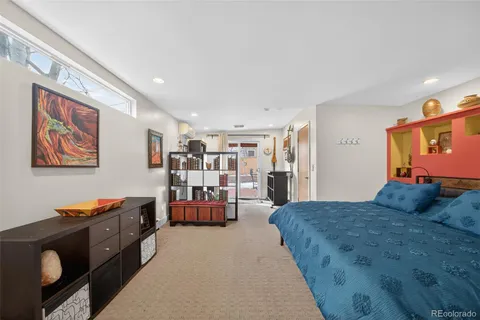 a bedroom with a bed and a potted plant