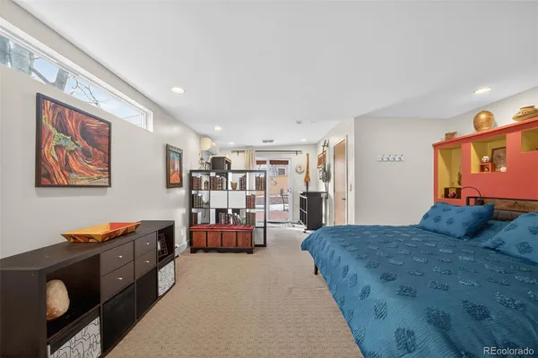 a bedroom with a bed and a potted plant