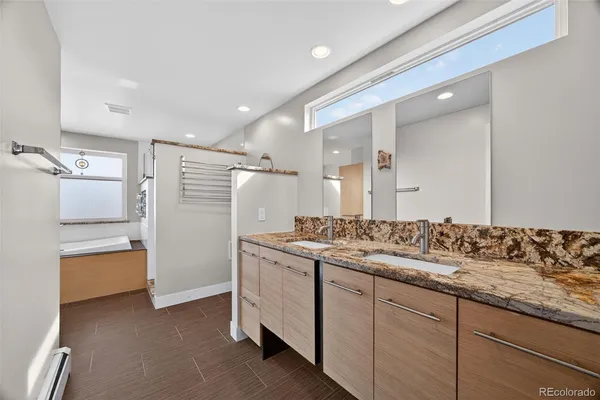 a bathroom with a tub and a window