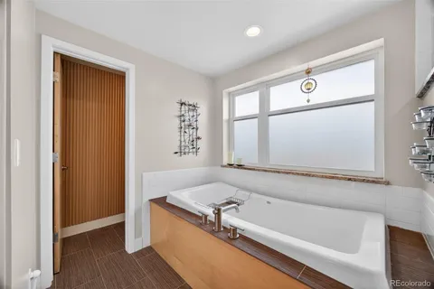 a bathroom with a tub and a shower