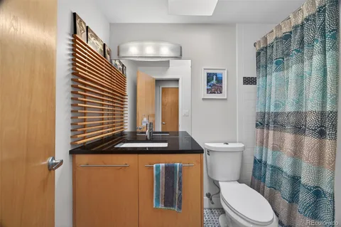 a bathroom with a sink a toilet and mirror