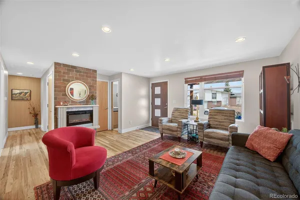 a living room with furniture a fireplace and a window
