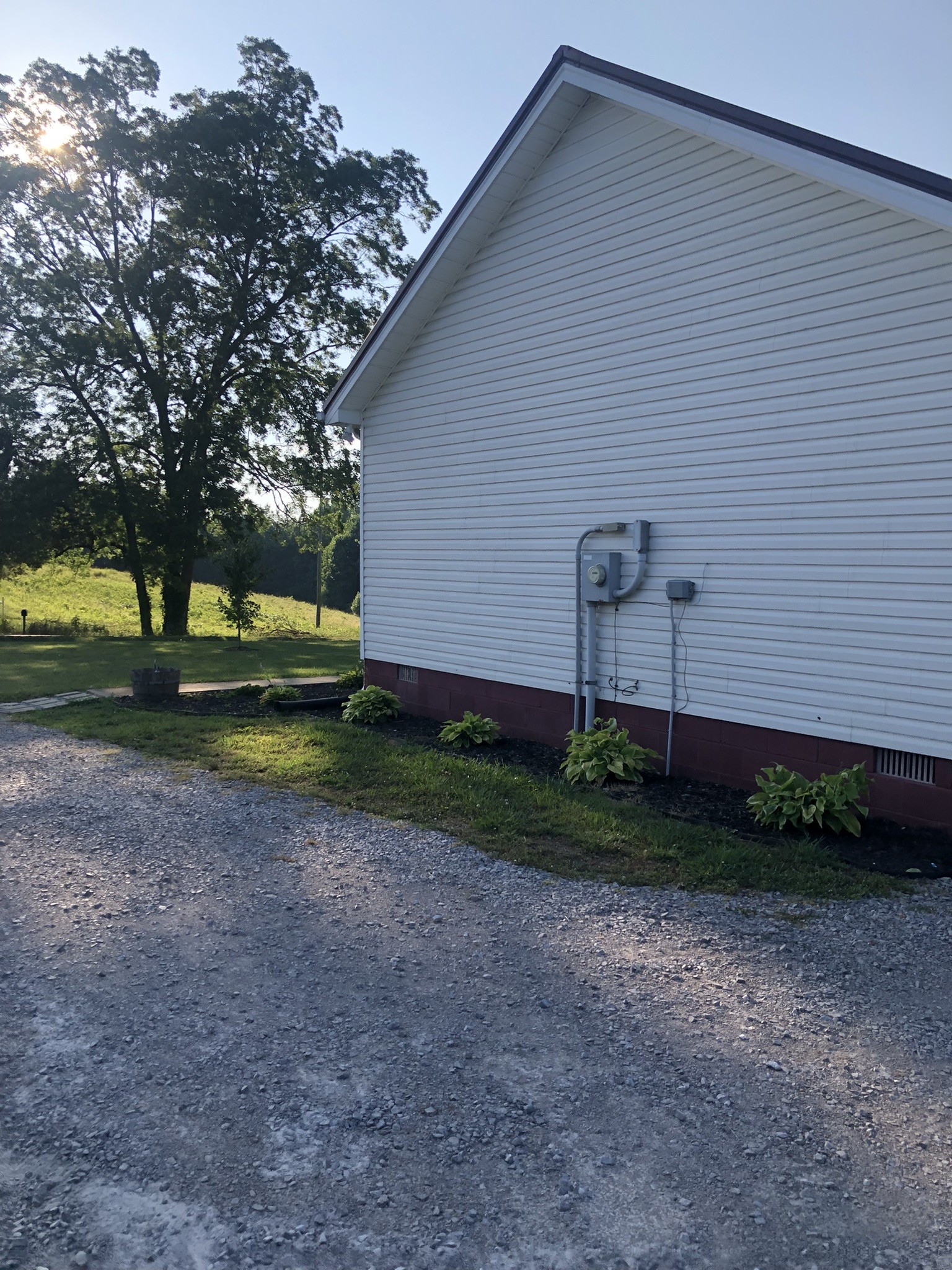 1075 Oak Grove Road Goodspring, TN 38460 - Photo 14 of 38 a backyard of a house with plants and large tree
