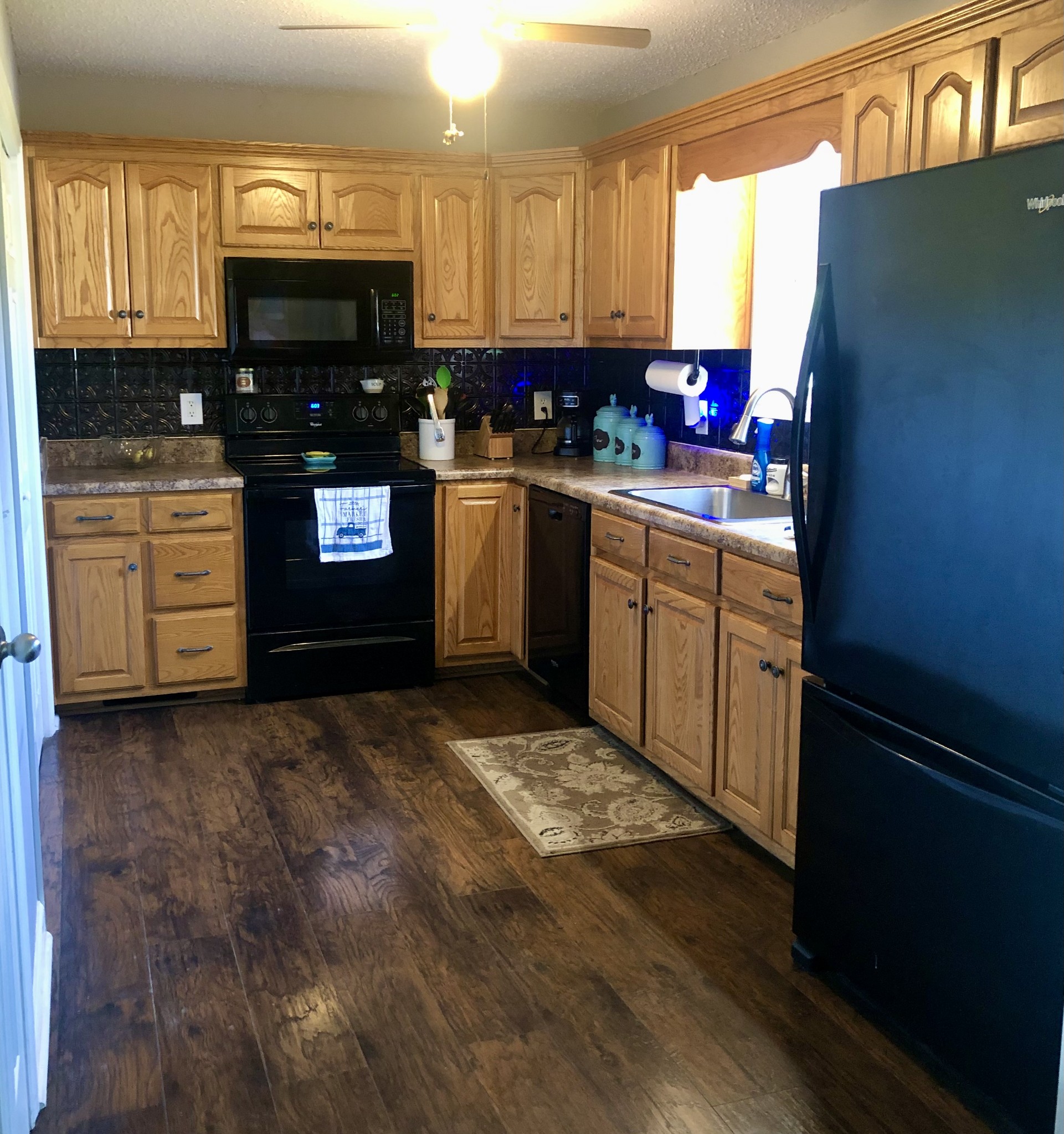 1075 Oak Grove Road Goodspring, TN 38460 - Photo 28 of 38 a kitchen with kitchen island granite countertop a stove a sink and a refrigerator
