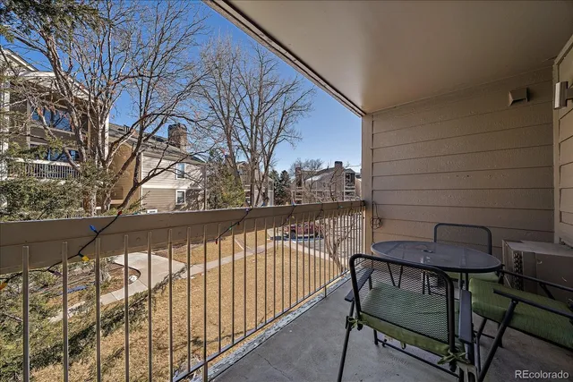 a view of balcony with wooden floor and outdoor seating