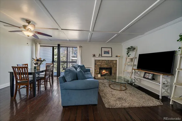 a living room with furniture a flat screen tv and a fireplace
